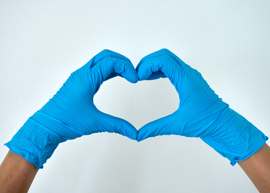 Hands with medical gloves making a heart