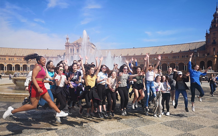 Student group jumping in front of the Plaza Mayor