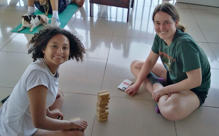 Student with host sister playing Jenga