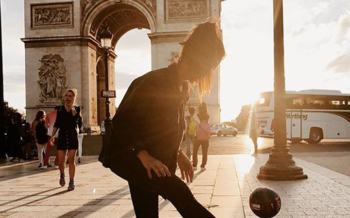 Girl playing ball at the Arc de Triomphe